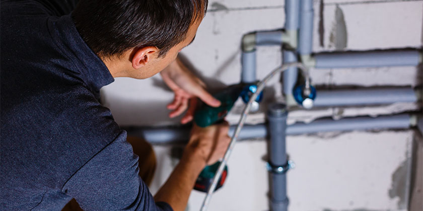 homem realizando reparos nas instalações de uma empresa